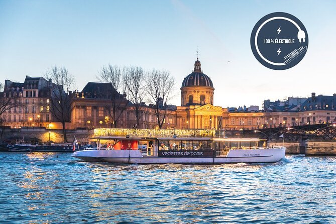 The dome of the Institut de France lit above the quay at dusk