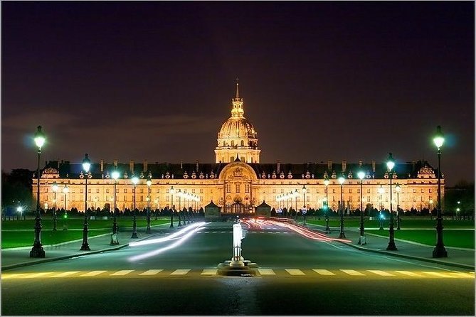 The gilded dome of Les Invalides floodlit at the end of its esplanade