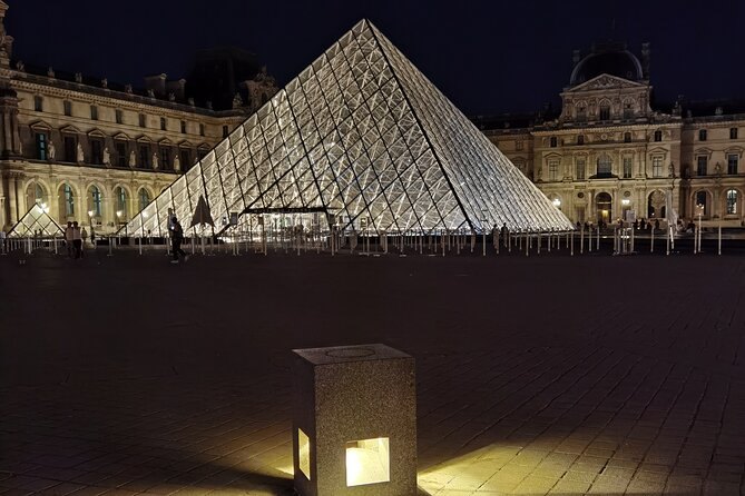The glass pyramid in the Louvre courtyard glowing after dark