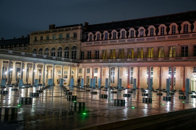 The Louvre's long riverside facade lit along the Rue de Rivoli