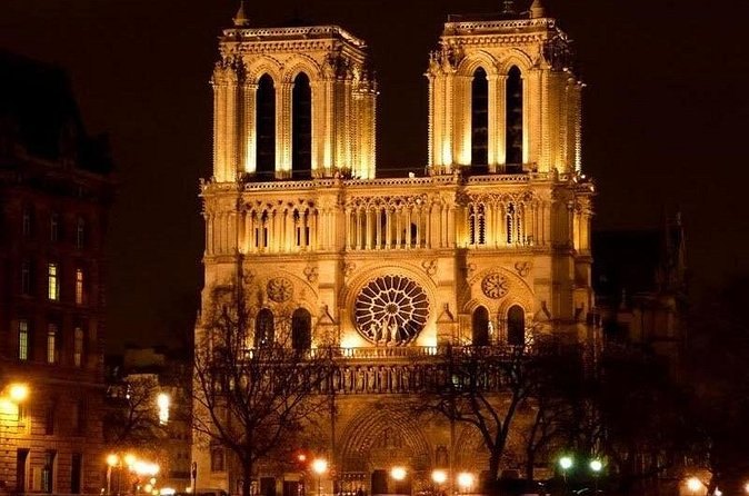 The west front of Notre-Dame de Paris floodlit after dark