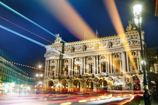 Light trails sweeping past the illuminated Palais Garnier opera house