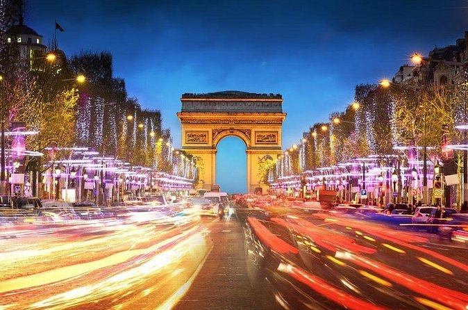 The Champs-&Eacute;lys&eacute;es at night, headlights streaming towards the Arc de Triomphe