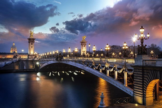 Pont Alexandre III and its gilded lamps reflected in the Seine at blue hour