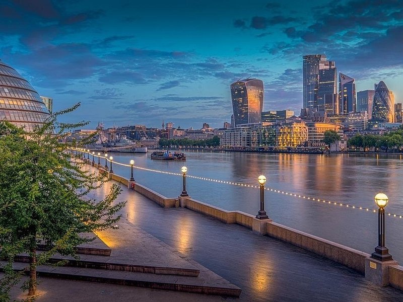 The Seine at blue hour with the bridges lit and the towers of La D&eacute;fense beyond